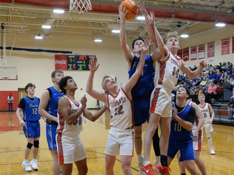 Fannin County’s Brody Henson and Copper Basin’s Talon Smith (14) battle for a rebound last Friday night along with Basin’s Drew Crowder (12) and Darrius Harris (50), and Fannin’s Holden Eavenson (10).