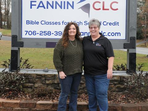 Fannin Christian Learning Center (CLC) Office Manager Alyssa Hooper, left, and Executive Director Tina Lee stand before the CLC sign.