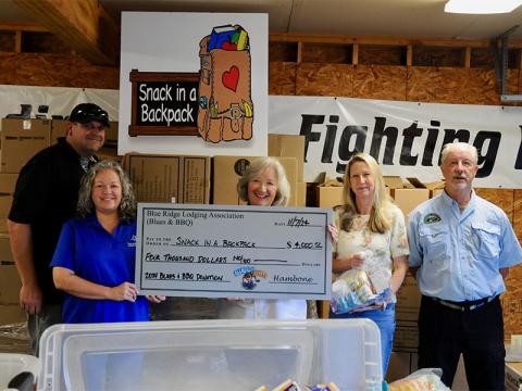 With funds raised from the 2024 Blues and BBQ event, committee members donated $4,000 to Snack in a Backpack Thursday, November 7. There for the check presentation is, from left, Paul Gribble, Dena Martin, Snack Executive Director Debby Beck, Heather Bradley and Greg Spencer.