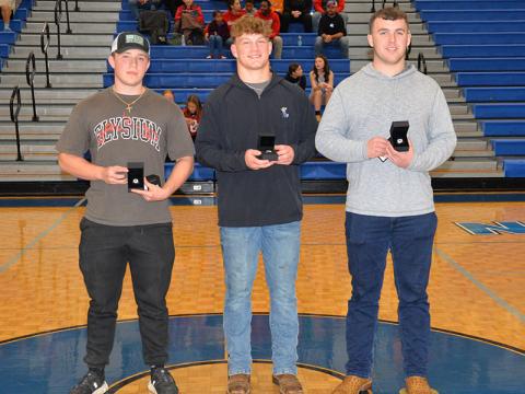 Sam McGill, Cooper Born and Case Holloway, from left, display the rings they received Tuesday night, December 17, honoring them as Georgia State Champion weightlifters. 