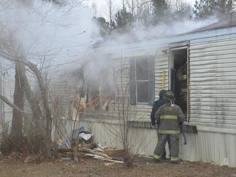 Fannin County firefighters had to tear out part of a wall of this mobile home off Austin Street in Blue Ridge to stop an early morning fire from spreading throughout the structure.