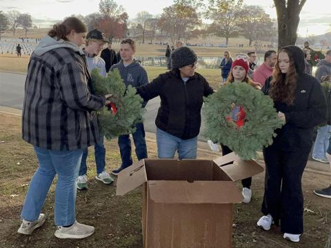 Each student collected a wreath to place during the Wreaths Across America service project that Copper Basin High School’s (CBHS) senior class attended. Pictured at the event, from left, are seniors Alyvia Harris, Malachi Kemper, Noah Thompson, CBHS Teacher Zulma Youngs who helped coordinate the project, seniors Anna Ballew and Nicole Kimsey.