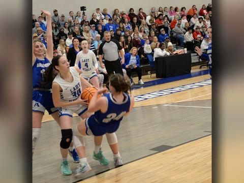 Avi Ethington fights against two Armuchee Lady Indians as she works for a shot Friday night in Calhoun.