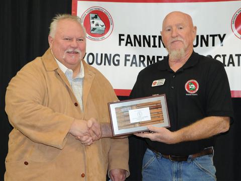 Greg Staffins, left, is presented with the Outstanding Member Award for 2024 during the Fannin County Young Farmers Association’s Awards Banquet Friday, January 24. Association President Kenny Queen presents the award.