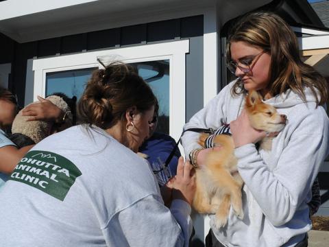 Volunteer Grace Haberman is shown holding a dog while Dr. Grace Murray of Cohutta Animal Clinic gives the dog a vaccine at the Barking Buddies free vaccine clinic. 