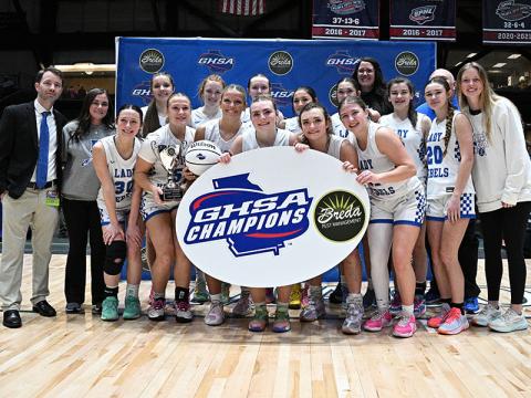 Photo courtesy All Star Photos Shown after their Saturday win in the Macon Coliseum are, from left, front, Avi Ethington, Callie Ensley, Emma Holloway, Maggie Ledford, Reese Lewis, and Izzie Jabaley; and, back, Head Coach Ryan Chastain, Assistant Coach Jenna Young, Brooklyn Owenby, Albany Cole, Emma Buchanan, Saige Turner, Sadie Patton, Assistant Coach Megan Orton, Toccoa Hampton, Assistant Coach Randy Hallmark (hidden), Kendall Gaddis and Assistant Coach Morgan Holt. 