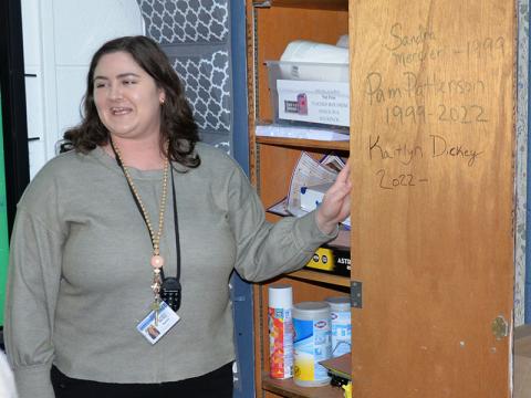 Fannin County English teacher Kaitlyn Davis showed Leadership Fannin members the inside of a cabinet door in her classroom with the names of the teachers in whose footsteps she follows, Sandra Mercier and Pam Patterson.