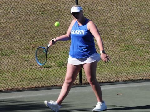 Junior Kendall Clore lines up her return in a March 18 home tennis game.