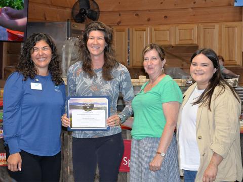 Fannin County Chamber of Commerce President Christie Gribble, left, presents Ashley Hoppers, of Mercier Orchards, with a certificate in recognition of their Commitment to Conservation Tuesday, April 22. They are also shown with, from left, Becky Griffin and Emily Owenby.
