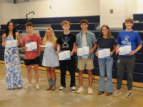 Wrestling team members receive academic awards April 28. From left, Emma Shaw, Landon Poole, Venice Oliver, Bentlee Jackson, Conrad Head, Makenzie Duvall and Copland Thomas.