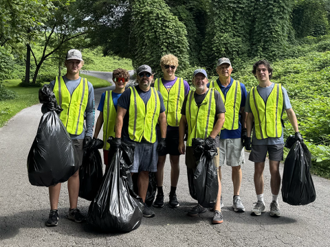 Pastor Corey Pelton and a group of volunteers from Rural Church Development are shown with some of the bags filled with trash they cleaned up in Copperhill.  