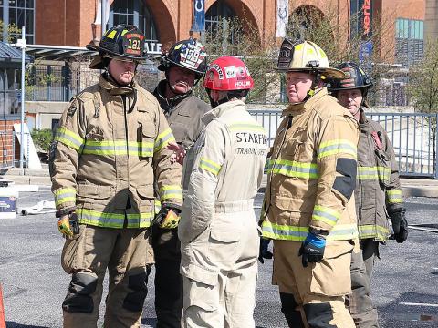 Fannin County firefighters Brett Crane, Earl Maddox, Leigh Hollins, Josh Curtis and Mike Miller plan a lesson at the FDIC conference.
