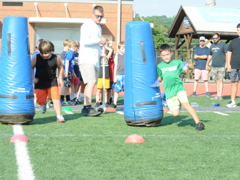 Coach Jack Roper sends new players through a drill to help them learn proper tactics to avoid blockers.