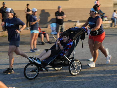 Aiden Mullins races in the Blue Ridge Freedom 5K. Mullins was one of five racers taking part in the Friday morning event thanks to the volunteers working with the Kyle Pease Foundation. The foundation works to provide opportunities for athletes with disabilities. Ashley Weeks is Fannin County’s Community Engagement Coordinator for the organization.