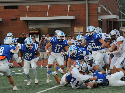 Fannin County’s defense swarms a Gilmer ball carrier Friday. The Rebels’ Reid Holloway (6) is on the bottom of the pile as, from left, Judah Wood (8), Conrad Head (22), Bryson Cole (11), Cayden Reece (62) and Isaac Watkins (50) converge.