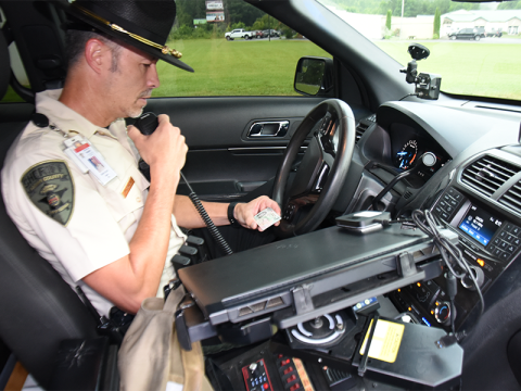 Fannin County Deputy Sheriff Captain Darvin Couch checks the drivers license of a driver stopped for speeding in the Blue Ridge Elementary School Zone on Highway 515. Until now, Couch said deputies had been working to educate drivers as to the speed limits. Now, deputies will be issuing citations.