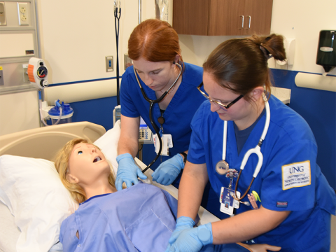 University of North Georgia (UNG) nursing students Lydia Bryan, left, and Makayla Patton demonstrate the state of the art “patient” that will be used in the nursing program at the UNG Blue Ridge Campus. The demonstration was part of the ribbon cutting event for the David E. Ralston Hall.