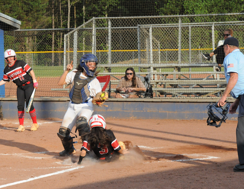 Sydney German takes a throw for the Fannin County Lady Rebels as an opponent slides into home plate in recent action in Blue Ridge.