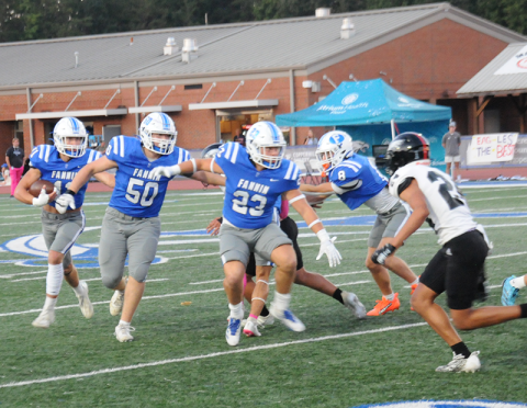 Fannin County’s Isaac Watkins (50), CJ Reece (23), and Judah Wood (8) clear a path for Bryson Cole (11) in action against the Coosa Eagles Friday at the Fannin County High School stadium.