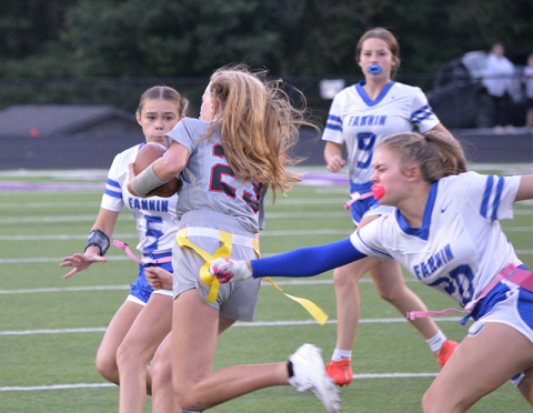 Fannin high flag football junior AnnaLeigh Cheatham (#20) pulls the flag of a Dalton Academy player as sophomore Kendall Gaddis (#5) runs for the tackle and Lynnex Patterson (#9) runs to assist. Fannin won the game 35-6 in Gilmer County Oct. 9.