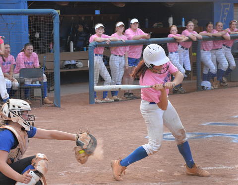 A Lady Rebel sets her eyes on a hit as her teammates look on in recent softball action. The Fannin County High School softball team earned a trip to the state playoffs with a game scheduled for today, Wednesday, October 15.