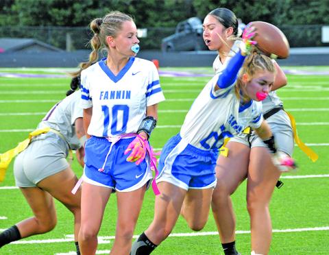 Fannin County High School flag junior Annaleigh Cheatham (#20) runs the ball while sophomore Makenzie Duvall blocks in action earlier this year.
