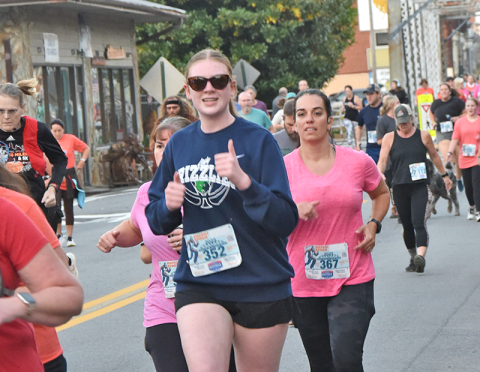 A runner gives a thumbs up as she makes her way along the Bigfoot Boogie course. 316 runners crossed the finish line this year.