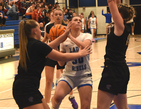 Avi Ethington battles through two defenders earlier this season for the Lady Rebels. She scored six points in Fannin County’s win over Morgan County.