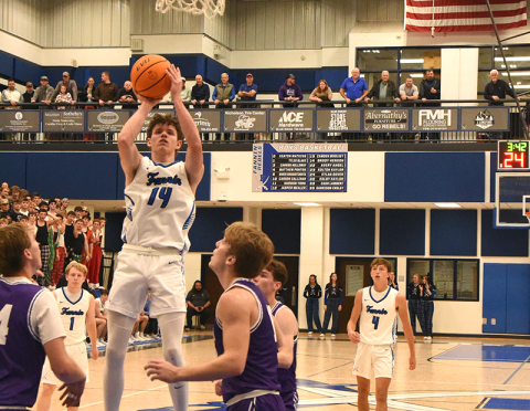 Brody Henson (14) eyes two of the 11 points he scored in Fannin County’s win over Union County Tuesday, November 25.