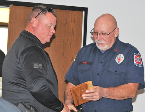 Justin Turner (left) accepts the Officer Of The Year award from Deputy Fire Chief Rob Ross at the Fannin County Fire Department’s annual Christmas dinner. 