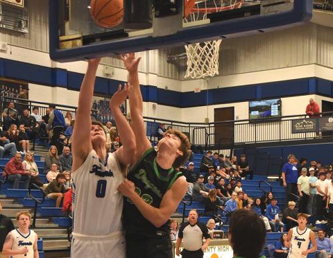 Keaton Watkins (0) battles for a rebound for the Fannin County Rebels earlier this season. He scored eight points in the Dade County win.