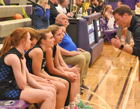 Fannin County Lady Rebel Coach Ryan Chastain, right, gives instruction to, seated, from left, Albany Cole, Reese Lewis, Maggie Ledford, Izzie Jabaley and Avi Ethington during the Piedmont Mountainside Holiday Classic tournament. - News Observer photo/Glenn Harbison