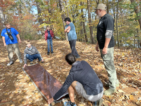Troop 32 scouts learn how to build a makeshift stretcher, which could become necessary for an unexpected accident deep in the forest.