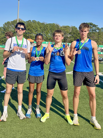 Winn Rickenbaker, Jamari Dunn, Braxton Cheatham and Hudson Lynch display their relay team medals from the Roswell meet.