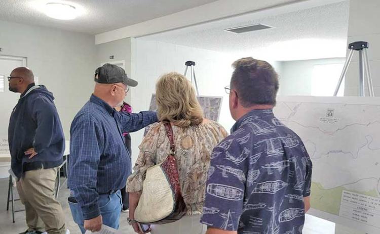 News Observer photo/Mollie Morrow - McCaysville Mayor Terry Arp, in the hat, shows citizens a map that GDOT provided showing where routes will be redirected when the concrete bridge is replaced during GDOT's Open House May 14.
