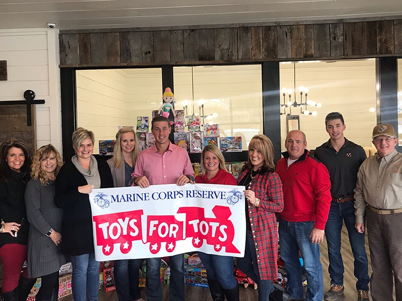 Nathan Fitts & Team with ReMax Realty won first place in the last Marine Toys for Tots challenge sponsored by Tracie Griffith with First Community Mortgage Group and Mountain Valley Community Bank. Shown, from left, are: Kristy Baugh, Griffith, Stacy Lewis, Sara Seastone, Nathan Fitts, Ashlee Picklesimmer, Kimberly Baugh, Ritchie Panter, Grant Fitts and Jim Brumbalow.