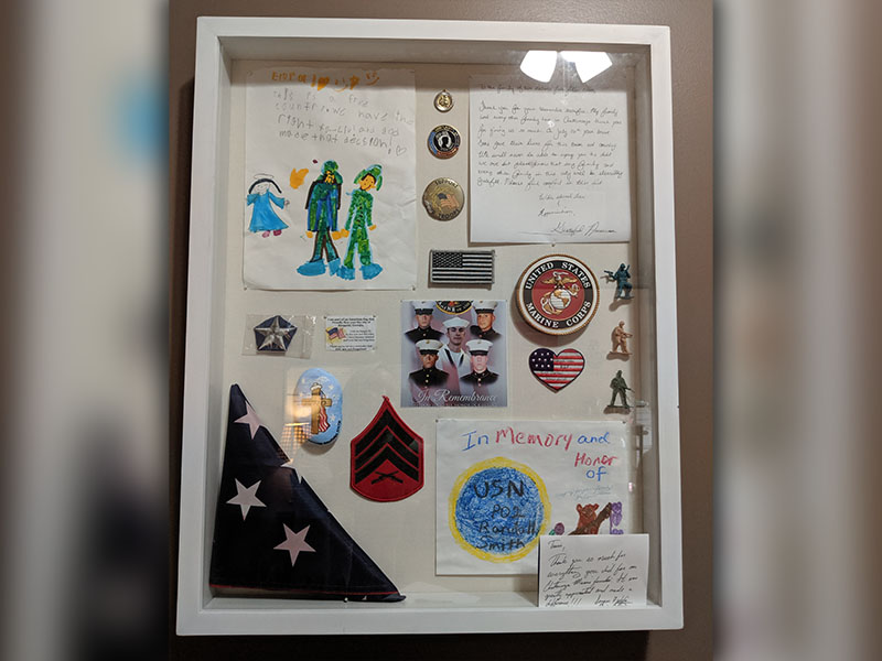 In Tracie Griffith’s office hangs a shadow box dedicated to the five fallen soldiers who were killed in an active shooter terrorist attack at their Reserves base in Chattanooga, July 16, 2015. The men were good friends with Griffith’s son who is also a Marine.