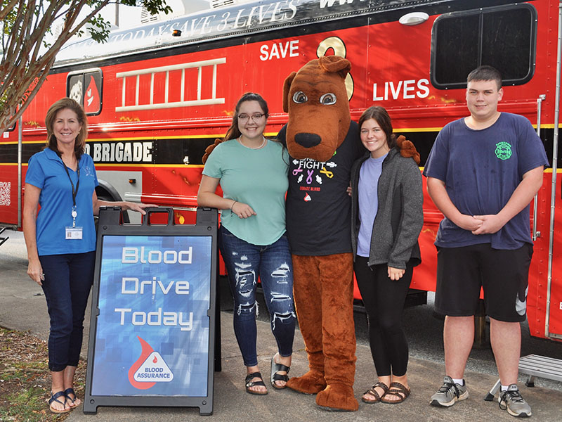 Fannin County High School students donate blood through Blood Assurance to help save lives Friday, September 20. Shown are, from left, teacher Anne Gibbs, Olivia Lowman, Trevor Couch as Hero, Mattie Prince and Caleb Couch.