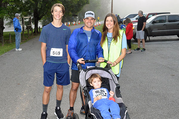 Runners and helpers pictured are, from left, front, Wilder Petrillo; back, Carter Mann, AJ Petrillo and Jamie Petrillo wait for the 5K to get started during the Boys & Girls Club of North Georgia Labor Day 5K River Run at Horseshoe Bend Park Saturday, August 31.
