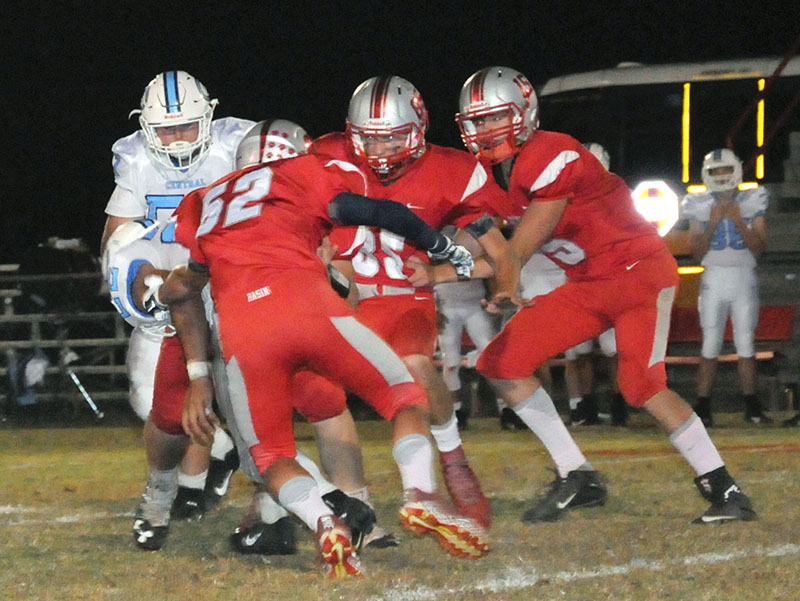 Copper Basin Cougars Larry Dye (52), Cody Montgomer (85) and Joe Boggs (15) wrap up a McMinn Central runner during Copper Basin’s game against the Chargers Friday, October 11.