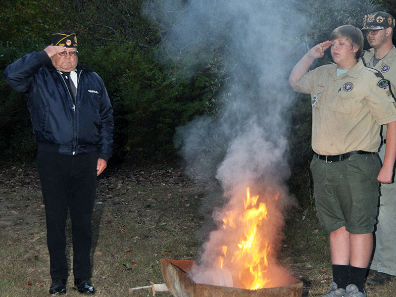  Members of local veterans organizations, the North Georgia Honor Guard and Boy Scout Troop 32, conducted a Flag Retirement ceremony at Ron Henry Horseshoe Bend Park Tuesday, October 22. Veteran Richard Crosley, left, and Boy Scout Ethan Jolly, right, salute an American flag as it is properly retired.