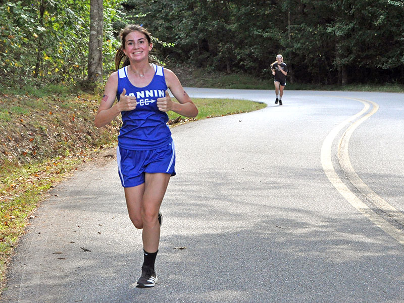 Lady Rebel cross country runner Monica Cosentino smiles as she competes in recent action for the Lady Rebels cross country team.