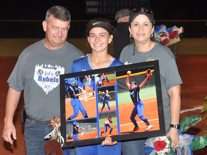 The 2019 Lady Rebel softball seniors were honored after their last home game of the season Thursday, September 26. Senior Lady Rebel Kaelyn Hensley is shown with her parents Jamie and Faith Hensley.