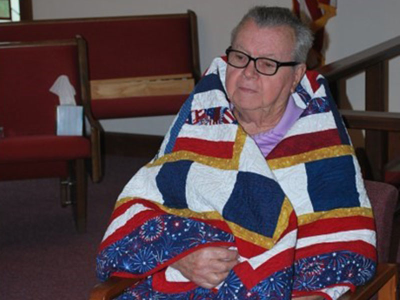 Quilt of Valor quilters Linda Gorman, Lula Williams and Sue Young from the Misty Mountain Quilters’ Guild in Blairsville were honored to award six Quilts of Valor to local veterans who have been touched by war. Kenneth Lee, from Morganton, shown here, served in the U.S. Navy and was deployed to the Korean Conflict. Kenny was in the Navy from 1954 through 1958. For his honorable service, Lee was awarded the Navy Good Conduct Medal.