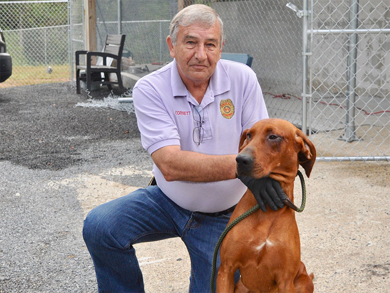 Animal Control Officer J.R. Cornett poses with a male Red Bone Hound who was found on Weaver Creek September 7. He is staying at Fannin County Animal Control until reclaimed or adopted. This sweet boy has a beautiful red coat with black patches around his eyes. View this handsome guy under Animal Control number 270-19.