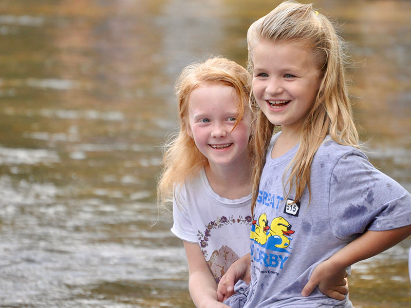 Eva Raque, left, and Harper Beadnell were excited to catch the first glimpse of the rubber ducks racing down the Toccoa River during the Boys & Girls Clubs of North Georgia’s annual Great 515 Duck Derby.