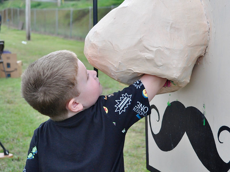 Logan Setser reached into a gigantic nose in order to retrieve a treat during Fannin County elementary schools’ Fall Festival.