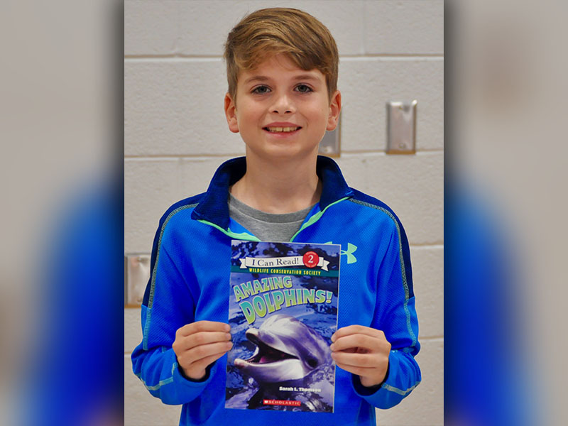 East Fannin Elementary School student Cash Lambert won a book while participating in the book walk at the school’s literacy night.