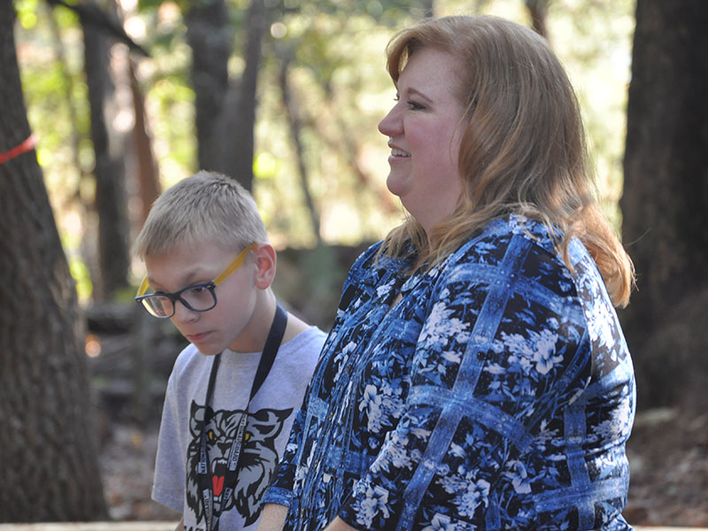 East Fannin Elementary School student Jonathan Jones and his mother, Dori Jones, enjoyed story time in the school’s outdoor classroom during a camping themed literacy night Wednesday, October 16.