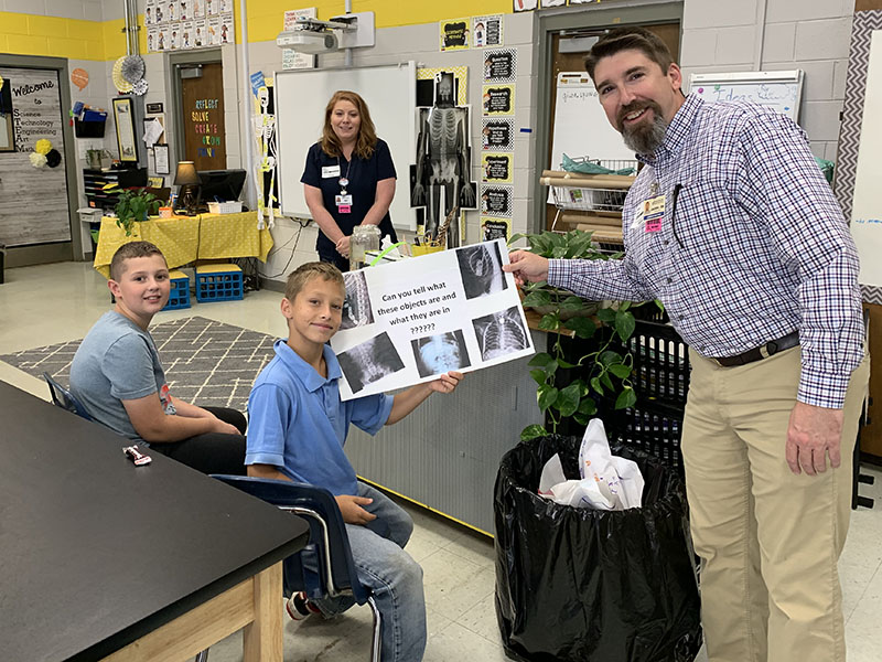 Fannin Regional Hospital partnered with West Fannin Elementary School to teach fifth grade students about a variety of medical subjects including bone health. Students, from left, Eli Queen and Isaiah Dell are shown with Imaging Director Amy Hughes and Interim CEO Jason Jones.